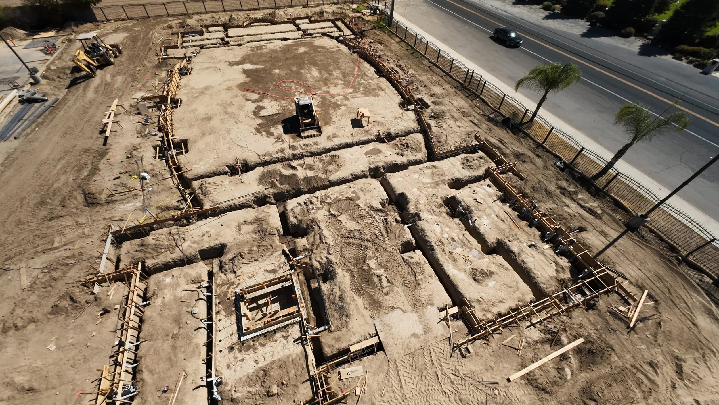 Aerial view of wooden foundation forms outlining the new Mar Addai Church building footprint