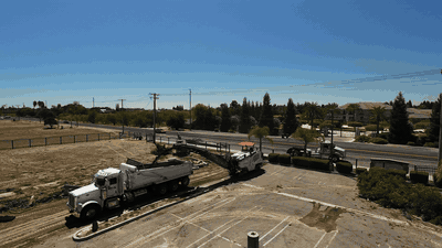 Timelapse of excavators clearing the parking lot during site preparation